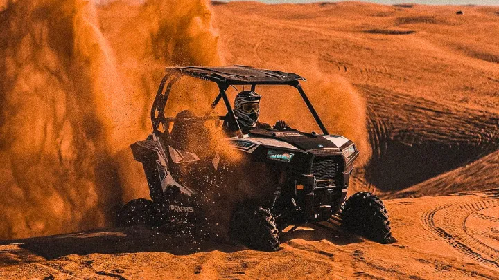 Dune Rush Adventure Tours - Desert landscape with ATV and dune buggy vehicles ready for adventure